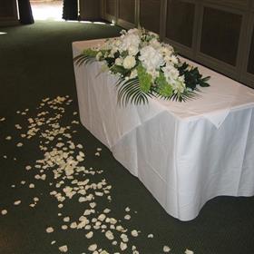 fwthumbRegistrar's table of white hydrangea, roses & molucella, with scattering of petals.jpg
